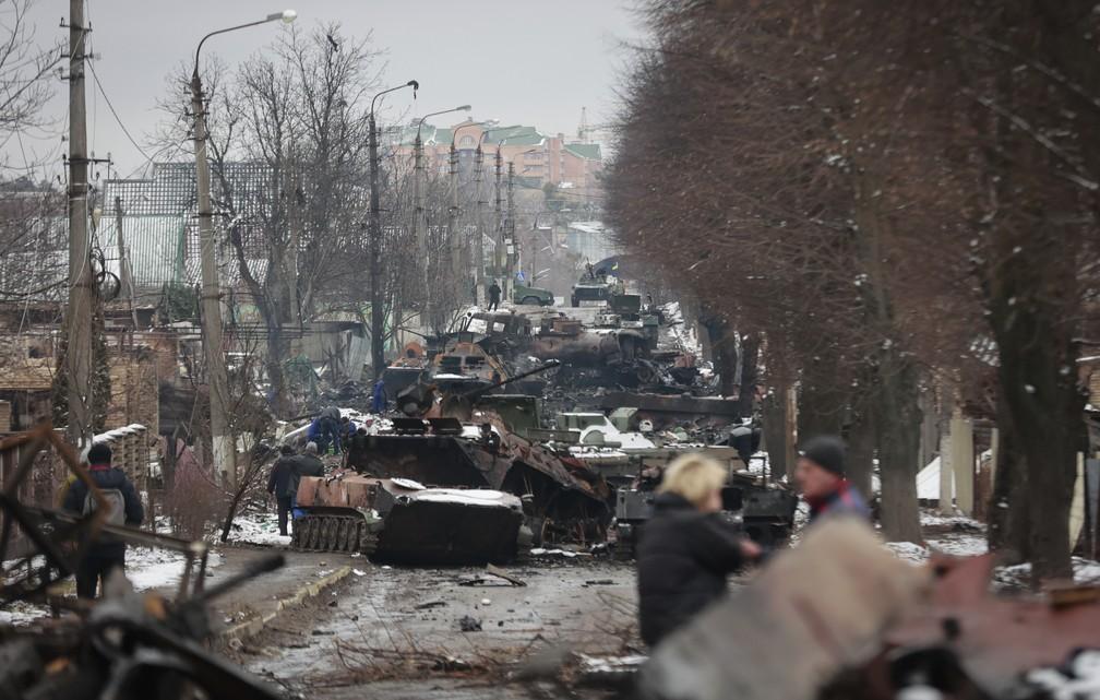 Moradores observam restos de veculos militares perto de Kiev Foto Serhii NuzhnenkoAP